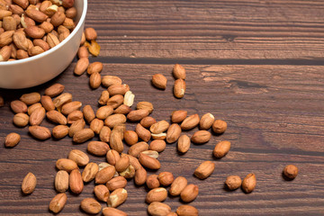 raw peanuts grains . on a wooden background. natural vegetarian vegetable protein . the view from the top.