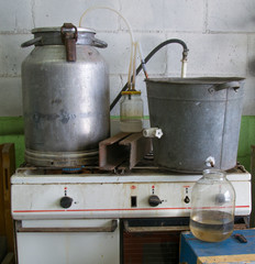 Home-made moonshine for the production of alcohol. Garage, gas stove, Russia 21st century