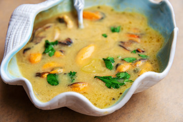 Traditional homemade greek mussels spicy soup cooked with olive oil and mustards