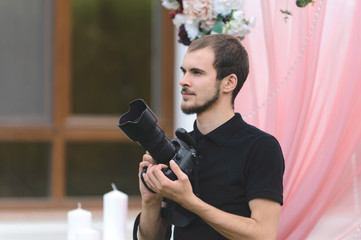 young man with camera at yard