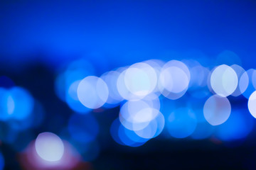 Blurred night city lights photo. Abstract blue pattern background in bokeh effect.