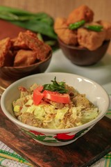 Soto Daging Tempe Goreng, is an Indonesian specialty like soup. Made from savory broth with beef cutlet and vegetable topping served with fried tempeh as condiment. 