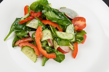 Vegetable vegetarian salad on white plate, closeup