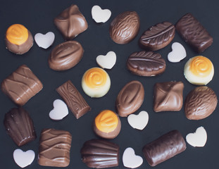 Delicious chocolates on a dark background.