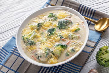 cheesy broccoli soup in a white bowl