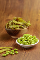 Fresh boiled edamame beans isolated on wooden background