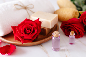 Fototapeta na wymiar Spa product with rose cream and.Rose petals on a marble background.