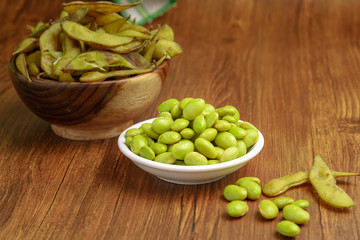 Edamame Beans Still lifeFresh boiled edamame beans isolated on wooden background