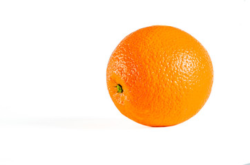 Juicy orange with textured skin closeup lies on a white background