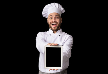 Chef Showing Tablet With Empty Screen Posing On Black Background