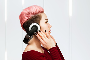 Obraz premium portrait of beautiful girl with headphones side view.