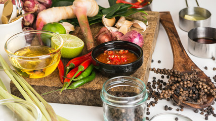 Spices for use as cooking ingredients on a wooden background with Fresh vegetables. Healthy food herbs. Organic vegetables on the table. Raw materials of cooking preparation Tom Yum.