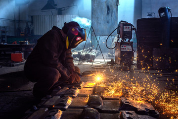 welder works at the factory as a welding machine