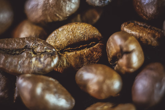coffee grains close-up on a black background. © Михаил 