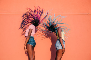 two women sisters dancing moving hair outdoor