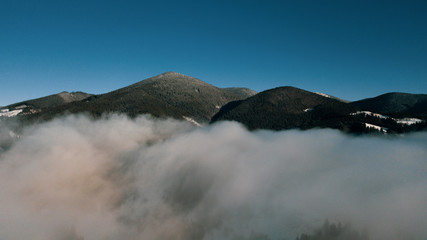 Beautiful landscape with mountain peaks covered with snow and clouds