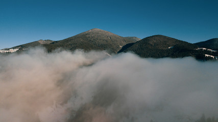 Beautiful landscape with mountain peaks covered with snow and clouds