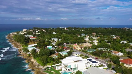 aerial drone footage of seven mile beach, west bay and george town on the island of grand cayman in the cayman islands in the clear blue and green tropical waters of the caribbean sea