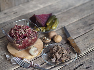 Salad roast beetroot, liver, nuts and pickles. Home kitchen. Wooden ancient background.