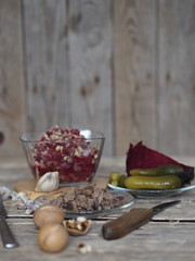Salad roast beetroot, liver, nuts and pickles. Home kitchen. Wooden ancient background.