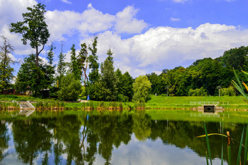 Fototapeta na wymiar The lake in Feofania park, sunny summer landscape in Kyiv, Ukraine on July 15, 2018. 