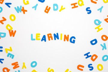 Colorful letters and the word learning on white background, learning or study concept