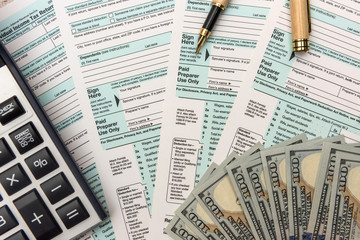 1040 Tax form with money and calculator. Tax concept