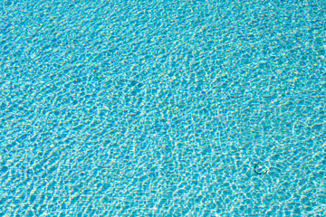 Fototapeta na wymiar Blue swimming pool reflecting the sun rippled