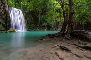 Beautiful natural scenic of Erawan waterfall tier three with emerald green pond named Pah Num Tok in Kanchanaburi, Thailand