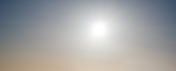 Sun glow in evening misty sky