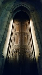 A door of St. Patrick's Cathedral glowing in the evening 