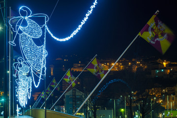 view on a bridge full of angels made of garland at christmas night