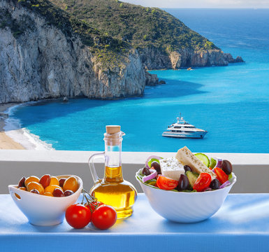 Milos beach with greek salad on Lefkas island in Greece