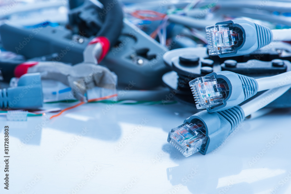 Wall mural tools and cables used in service of network ethernet patch cord close-up
