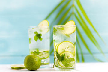 Lime soda a glass on a white wooden floor in a light blue background, summer drinks nonalcoholic