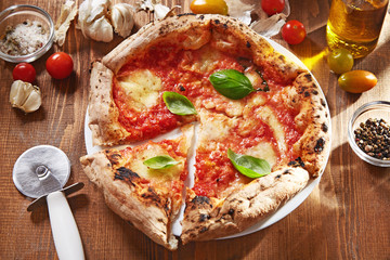 Pizza. Traditional italian pizza with ingredients on a wooden background viewed from above. Top view