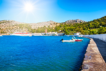 Fototapeta na wymiar View of bay with boats and Monastery of Taxiarchis Mihail Panormitis on Island of Symi (Rhodes, Greece)