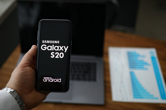 Businessman hold Samsung galaxy s20 smartphone in hand
