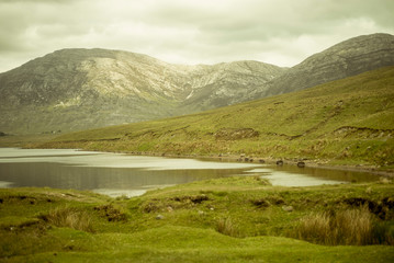 Fototapeta na wymiar Beautiful lake called Lough Inagh in County Galway, Ireland. Landscape with mountains in the background.