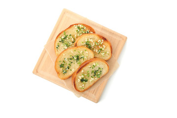 Board of toasted bread slices with garlic isolated on white background