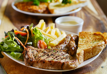grilled pork chop with french fries and salad thai style