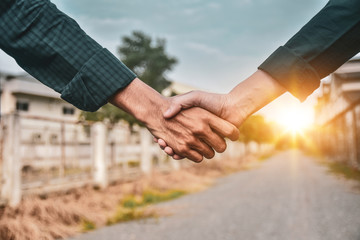 Engineering shake hand sunlight background