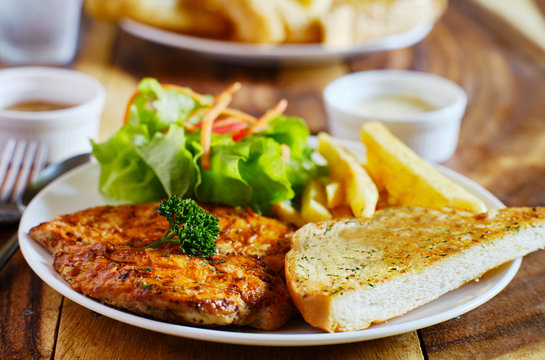 grilled chicken filet with french fries and salad thai style