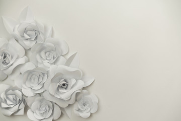 Paper flowers composition with copy space on right side, ideal for wedding designs, greeting cards, flower concepts.