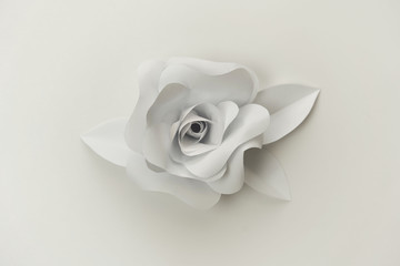 Beautiful paper rose flower close up photo on white background.