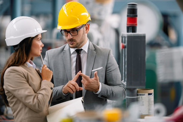 Architects working on construction project. Man and woman discussing work. 