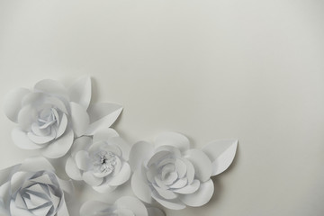 Hand crafted paper roses bouquet on white with copy space on right upper corner. Flower closeup background.