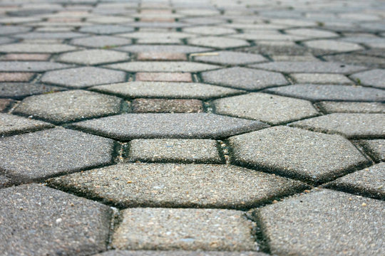 Brick path with blurred background, side walk, abstract pattern.