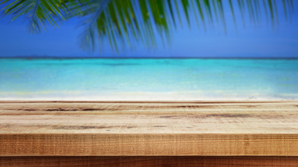 Blurred nature summer tropical beach and palm leaves background, Empty wooden. 