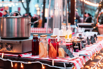 Sweet drinks in glass bottles on the table at the fair